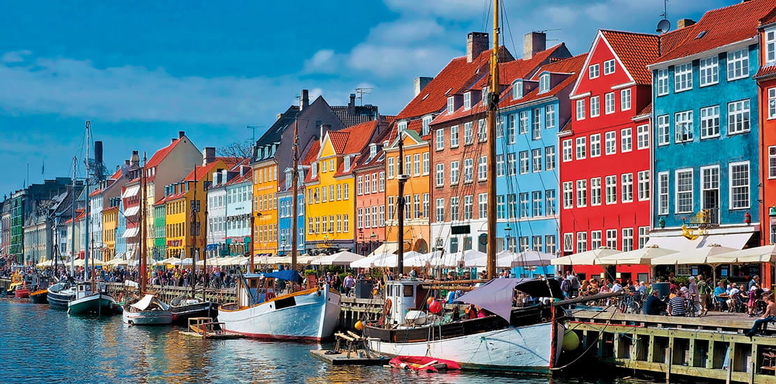 Colourful buildings lining a canal on the Nyhavn waterfront of Copenhagen, Denmark